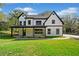 Striking two-story modern farmhouse with black-trimmed windows and a welcoming covered front porch at 2788 Browns Mill Se Rd, Atlanta, GA 30354