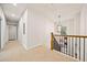 Upstairs hallway with a wood railing and view of downstairs through stairwell at 2788 Browns Mill Se Rd, Atlanta, GA 30354