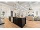 Open-concept living space featuring a kitchen island, coffered ceilings, and hardwood floors at 2788 Browns Mill Se Rd, Atlanta, GA 30354