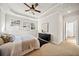 Cozy main bedroom featuring a tray ceiling, neutral tones, and an ensuite bathroom at 2788 Browns Mill Se Rd, Atlanta, GA 30354