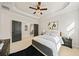 Bright main bedroom with a tray ceiling, neutral tones, and dual closets at 2788 Browns Mill Se Rd, Atlanta, GA 30354