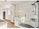 Beautiful walk-in shower with glass door, built-in bench and marble-look tiling at 2788 Browns Mill Se Rd, Atlanta, GA 30354