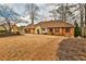 Attractive brick home featuring a manicured lawn, dark shutters, and a welcoming front entrance at 573 Ripplewater Sw Dr, Marietta, GA 30064