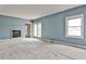 Cozy living room featuring a fireplace, neutral carpet, big window, and nice blue walls at 573 Ripplewater Sw Dr, Marietta, GA 30064