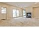 Spacious living room featuring a fireplace, neutral carpet, door and big window at 573 Ripplewater Sw Dr, Marietta, GA 30064