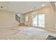 Spacious living room featuring stairs to the second floor, neutral carpet, and a window at 573 Ripplewater Sw Dr, Marietta, GA 30064