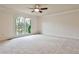 Large main bedroom featuring plush carpet, large windows with backyard view, and crown molding at 573 Ripplewater Sw Dr, Marietta, GA 30064