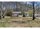 Quaint single-story home with a screened in porch nestled amongst mature trees at 6219 Holly Ann Se St, Acworth, GA 30102