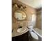 Bathroom with stone tile features, an ornate mirror, and a combined shower-tub at 6470 Wright Cir, Atlanta, GA 30328