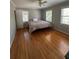 Sunlit bedroom with hardwood floors and views from multiple windows at 6470 Wright Cir, Atlanta, GA 30328