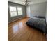 Bedroom featuring hardwood floors, natural light from a large window, and a comfortable bed at 6470 Wright Cir, Atlanta, GA 30328