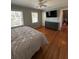 Well-lit bedroom with hardwood floors, a fan, and natural light at 6470 Wright Cir, Atlanta, GA 30328