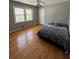 Cozy bedroom featuring hardwood floors, natural light, ceiling fan, and a serene color palette at 6470 Wright Cir, Atlanta, GA 30328