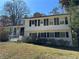 Charming two-story home with a brick exterior, trimmed black shutters and a well-maintained front yard at 6470 Wright Cir, Atlanta, GA 30328