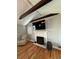 Inviting living room with a fireplace, beamed ceilings, a TV, and hardwood floors at 6470 Wright Cir, Atlanta, GA 30328