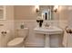 Charming bathroom with pedestal sink, decorative mirror, and classic fixtures at 1643 North Springs Dr, Dunwoody, GA 30338