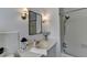 This bathroom features a shower/tub combo, vanity and decorative lighting at 1643 North Springs Dr, Dunwoody, GA 30338