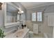 This bathroom features a shower/tub combo, vanity, mirror and decorative lighting at 1643 North Springs Dr, Dunwoody, GA 30338