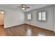 This bedroom features hardwood floors, two windows with shutters and a ceiling fan at 1643 North Springs Dr, Dunwoody, GA 30338