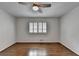 This bedroom features hardwood floors, one window with shutters and a ceiling fan at 1643 North Springs Dr, Dunwoody, GA 30338