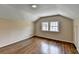 Bright bedroom features hardwood floors, neutral paint, and a large double window at 1643 North Springs Dr, Dunwoody, GA 30338