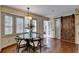 Bright dining room with bay windows and glass table with seating for four at 1643 North Springs Dr, Dunwoody, GA 30338