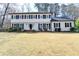 Charming two-story home boasts a classic white exterior and a well-manicured front yard at 1643 North Springs Dr, Dunwoody, GA 30338