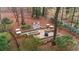 Aerial view of the beautifully landscaped backyard featuring lush greenery, hardscape design, and mature trees at 4655 Jett Rd, Atlanta, GA 30327