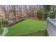 Beautifully landscaped backyard with stone retaining wall and lush green lawn at 4655 Jett Rd, Atlanta, GA 30327