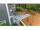 Aerial view of backyard stone patio, landscaping, and house with gray siding at 4655 Jett Rd, Atlanta, GA 30327