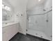 Bright bathroom featuring glass enclosed shower, neutral tile, and white vanity with marble countertop at 4655 Jett Rd, Atlanta, GA 30327