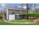 View of the home's garage and covered parking, stone pathway, and cedar shake siding at 4655 Jett Rd, Atlanta, GA 30327