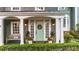 Inviting front porch with a charming light-green door, potted plants, and a cozy bench at 4655 Jett Rd, Atlanta, GA 30327