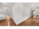 Long hallway with hardwood floors and doors leading to various rooms at 4655 Jett Rd, Atlanta, GA 30327