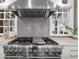 Gourmet kitchen features a stainless steel range hood, gray subway tile, and a professional grade gas range at 4655 Jett Rd, Atlanta, GA 30327