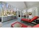 Outdoor kitchen and lounge chairs on covered patio with neutral colors and ceiling fan at 4655 Jett Rd, Atlanta, GA 30327