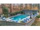 Backyard pool area with lounge chairs and a pool house surrounded by trees at 4655 Jett Rd, Atlanta, GA 30327