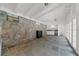 Inside the pool house with stone accent wall, tile floor, white ceilings and trim and modern appliances at 4655 Jett Rd, Atlanta, GA 30327