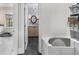 Hallway leading to a powder room with dark tile floors and sink at 4655 Jett Rd, Atlanta, GA 30327