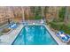 Aerial view of a large backyard pool with various seating and lush landscaping at 4655 Jett Rd, Atlanta, GA 30327