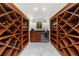 Spacious wine cellar with wooden wine racks, custom cabinetry, and a beverage fridge at 4655 Jett Rd, Atlanta, GA 30327