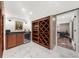 Well-organized wine cellar featuring wooden racks, storage cabinets, and a wine cooler at 4655 Jett Rd, Atlanta, GA 30327