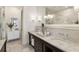 Luxurious bathroom featuring marble countertops, double sinks, modern lighting, and a glass-enclosed shower at 5821 Clarion St # J8, Cumming, GA 30040