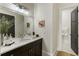 Bright bathroom featuring double sinks with marble countertops, a large mirror, and modern fixtures for a luxurious feel at 5821 Clarion St # J8, Cumming, GA 30040