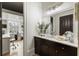 Modern bathroom with dark cabinets, marble countertop, and stylish decor, reflecting a bright office space in the mirror at 5821 Clarion St # J8, Cumming, GA 30040