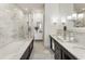 Modern bathroom featuring marble tile, a soaking tub, glass enclosed shower, and double vanity at 5821 Clarion St # J8, Cumming, GA 30040