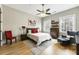 Cozy bedroom featuring hardwood floors, a ceiling fan, and large windows that let in plenty of natural light at 5821 Clarion St # J8, Cumming, GA 30040