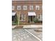 Charming brick building featuring reserved condo resident parking and well-maintained landscaping at 5821 Clarion St # J8, Cumming, GA 30040