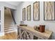 Hallway featuring a staircase, display cabinet and decorative wall hangings at 5821 Clarion St # J8, Cumming, GA 30040