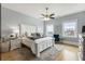 Bright main bedroom with ample natural light, hardwood floors, and a classic white bed frame at 5821 Clarion St # J8, Cumming, GA 30040